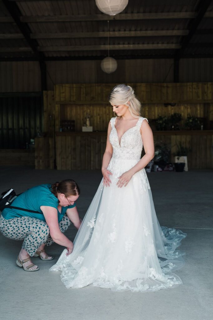 Your Wedding Friend, adjusting a train of our bride about to wlak out to meet her fiance