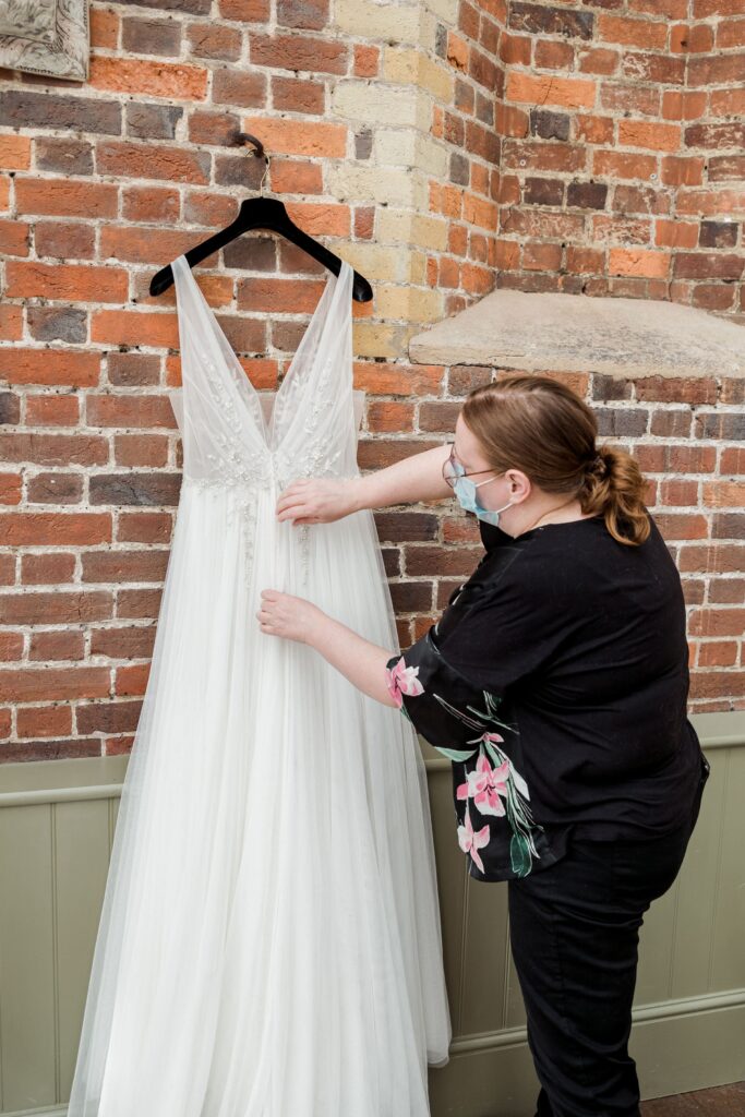 Your Wedding Friend Fixing a bridal dress