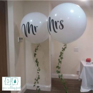 Helium filled Mr and Mrs Balloons with ivy attached on the string