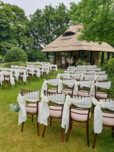 outdoor ceremony seating facing a rustic conservatory